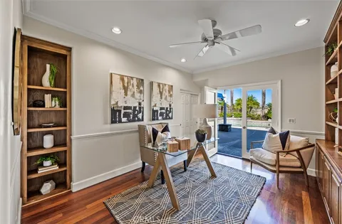 a spacious bedroom with a bed a large window with table and chairs