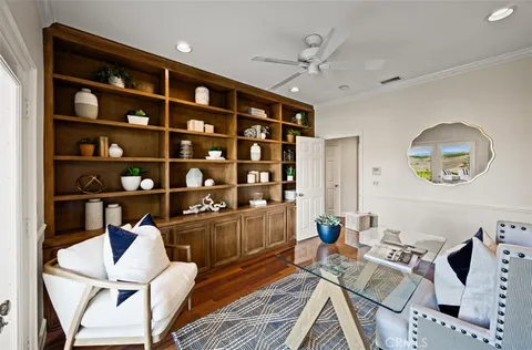 a spacious bedroom with a bed a table and flat screen tv