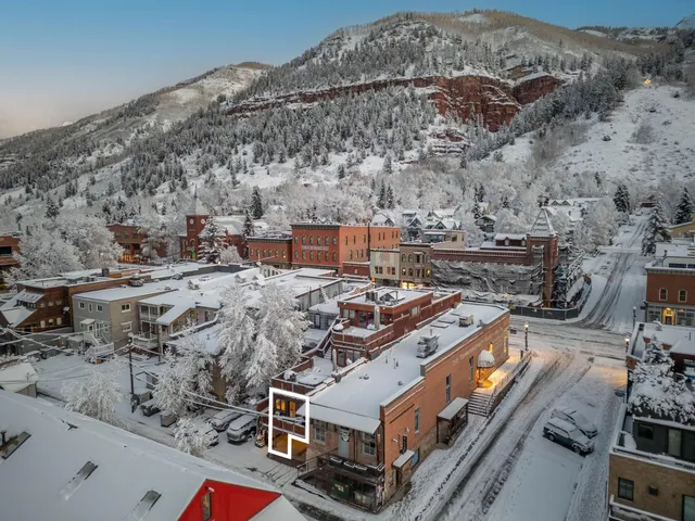 an aerial view of a city with mountain