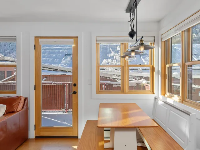 a large bed sitting in a bedroom next to a window