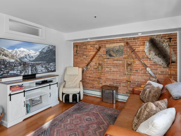 a large bed sitting in a bedroom next to a window