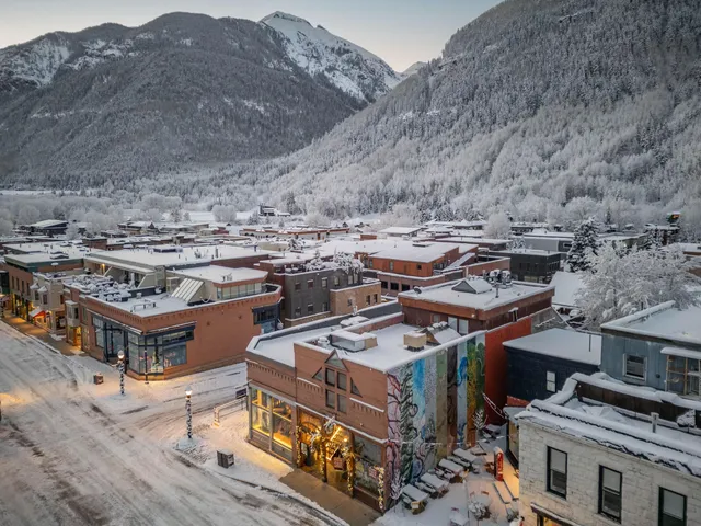 a picture of a bench in front of a wall