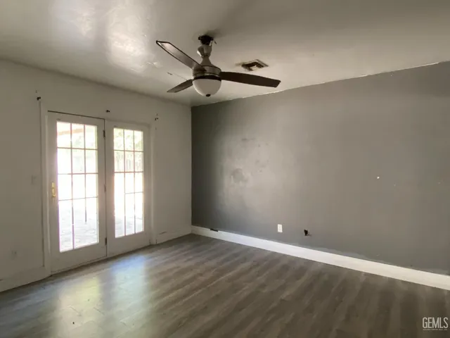 a view of kitchen with cabinets and window