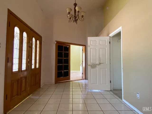 a large kitchen with stainless steel appliances a large counter top and a wooden floors