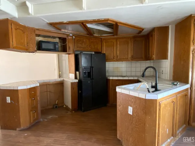 a bathroom with a granite countertop toilet a sink and a bathtub