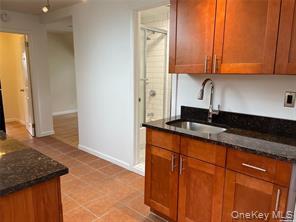 85-04 89th Street, Unit 3 Queens, NY 11421 - Photo 1 of 1 a kitchen with granite countertop cabinets sink and stove
