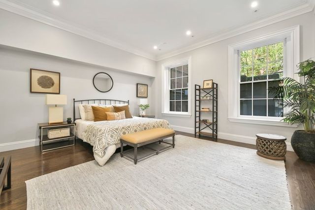 a spacious bedroom with a bed and a large window