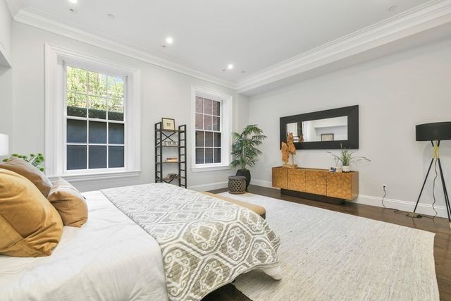 a bedroom with a large bed and a large window