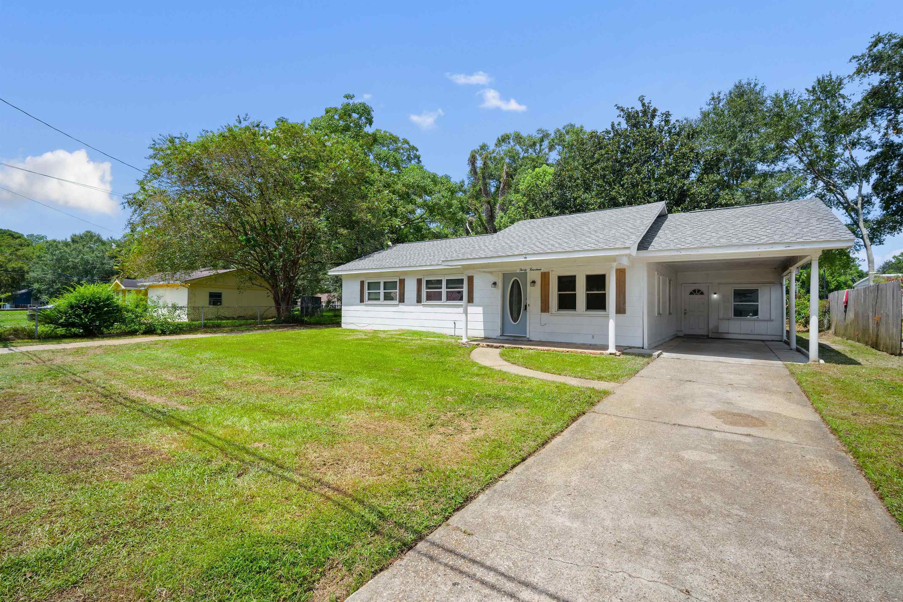 3014 Farcott Street Mobile, AL 36606 - Photo 2 of 26 View of front of property featuring an attached carport, driveway, covered porch, and a shingled roof