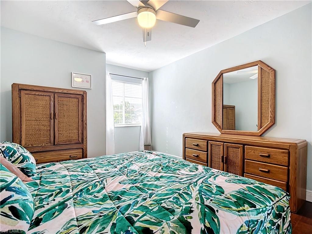 2860 Citrus Lake Drive, Unit R202 Naples, FL 34109 - Photo 26 of 50 a bedroom with a bed and a dresser