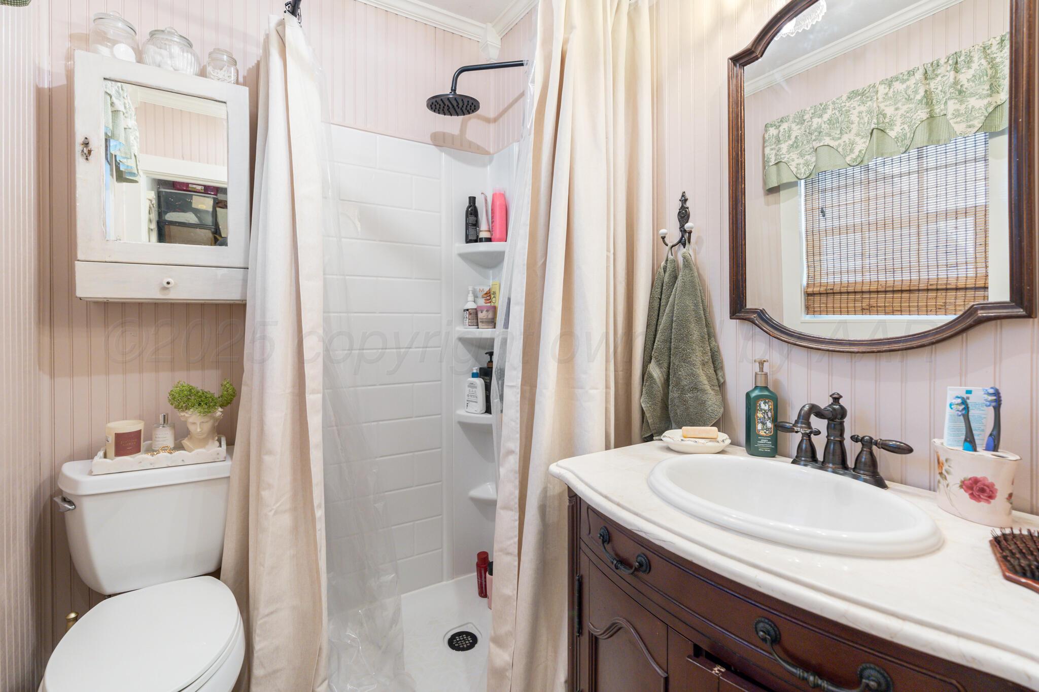 5211 River Road Amarillo, TX 79108 - Photo 20 of 39 a bathroom with a sink toilet and shower