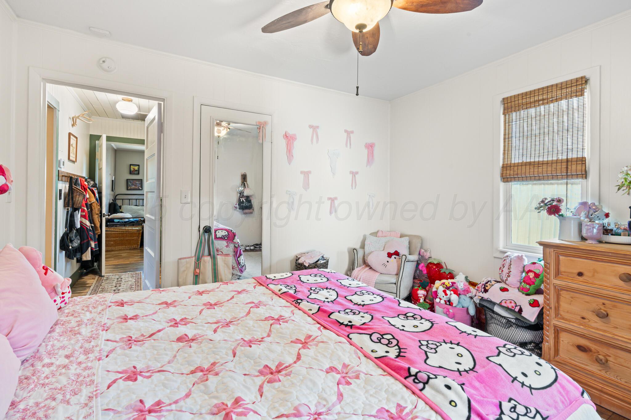 5211 River Road Amarillo, TX 79108 - Photo 23 of 39 a bedroom with a bed closet and a large mirror
