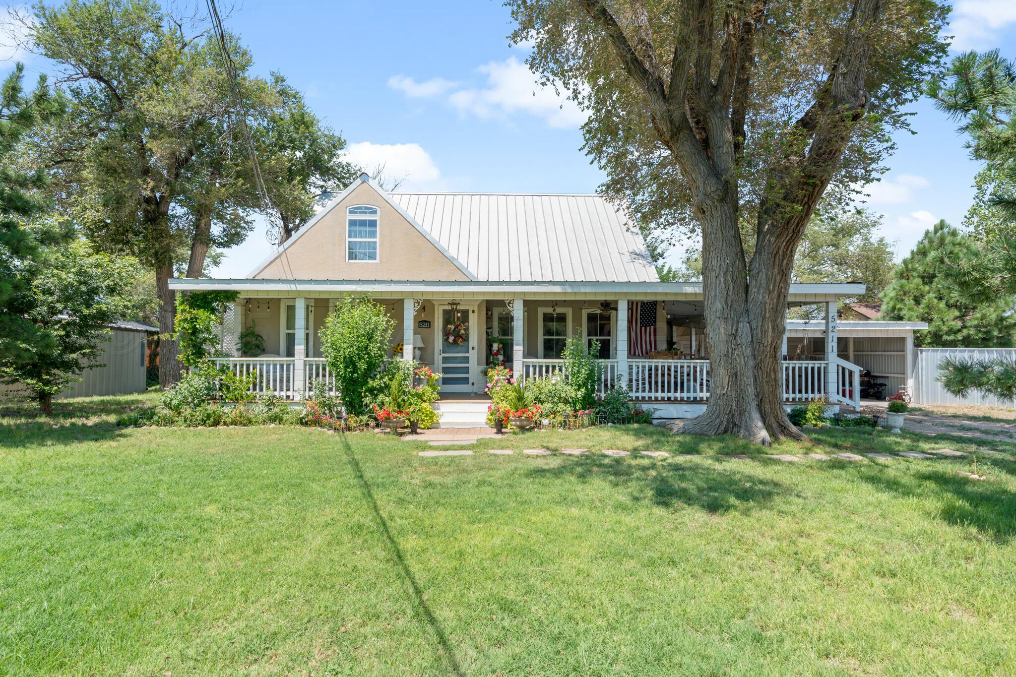 5211 River Road Amarillo, TX 79108 - Photo 5 of 39 a front view of a house with a yard and trees