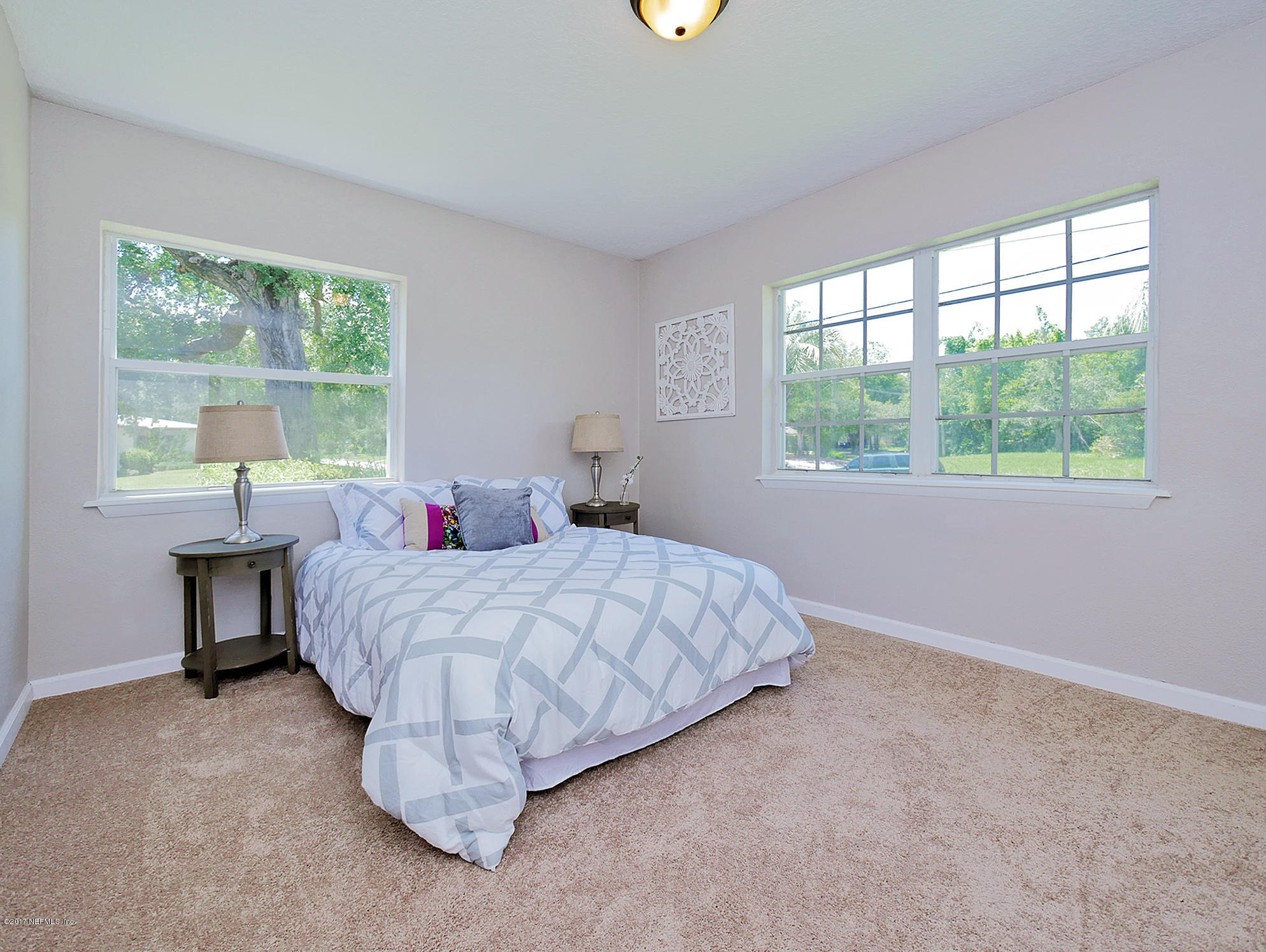 2448 Clemson Road Jacksonville, FL 32217 - Photo 11 of 21 a bed room with a bed and a chair