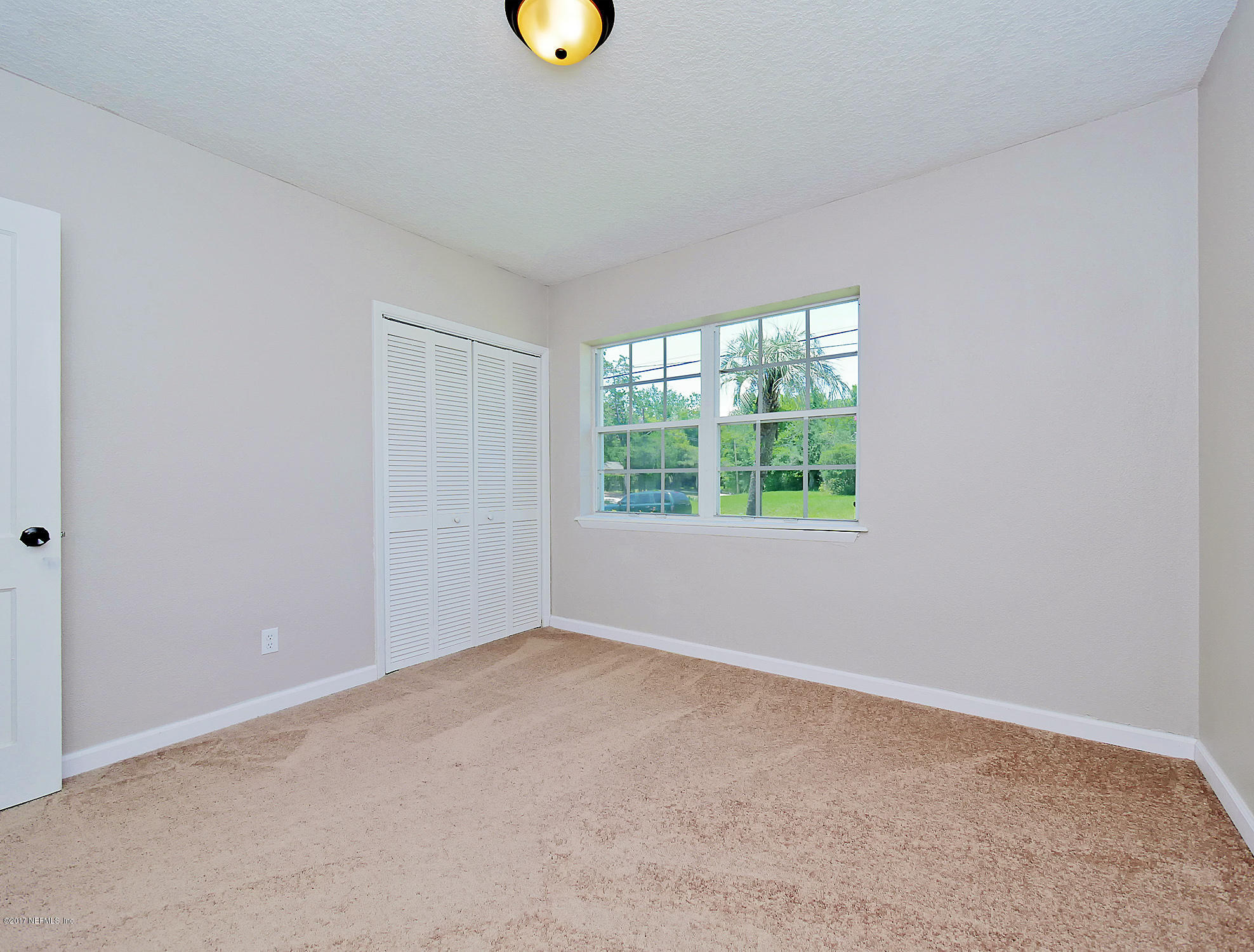 2448 Clemson Road Jacksonville, FL 32217 - Photo 13 of 21 an empty room with a window
