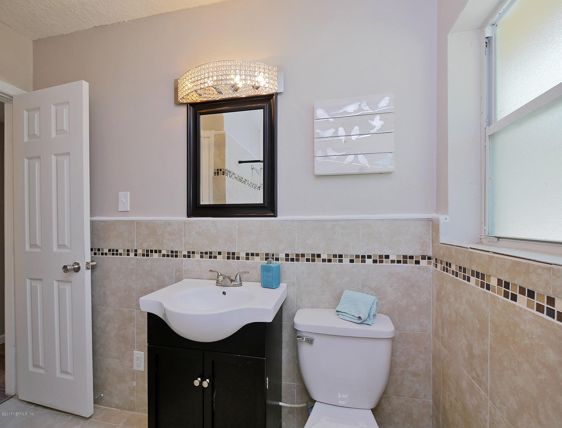 2448 Clemson Road Jacksonville, FL 32217 - Photo 14 of 21 a bathroom with a toilet a sink and mirror