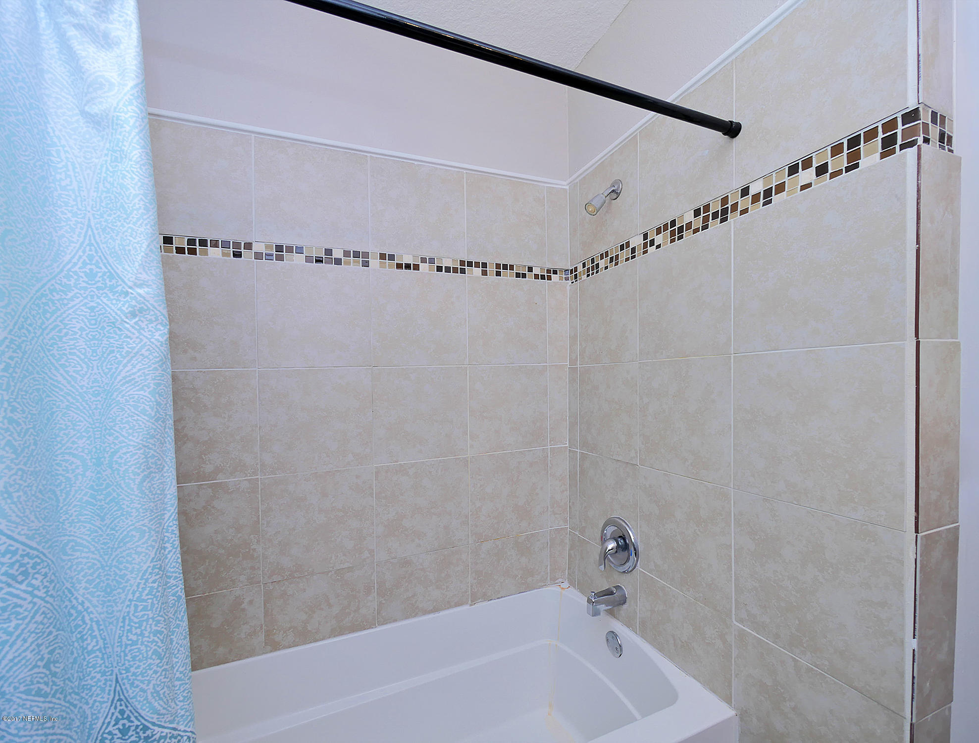 2448 Clemson Road Jacksonville, FL 32217 - Photo 15 of 21 a bathroom with a shower and a bath tub