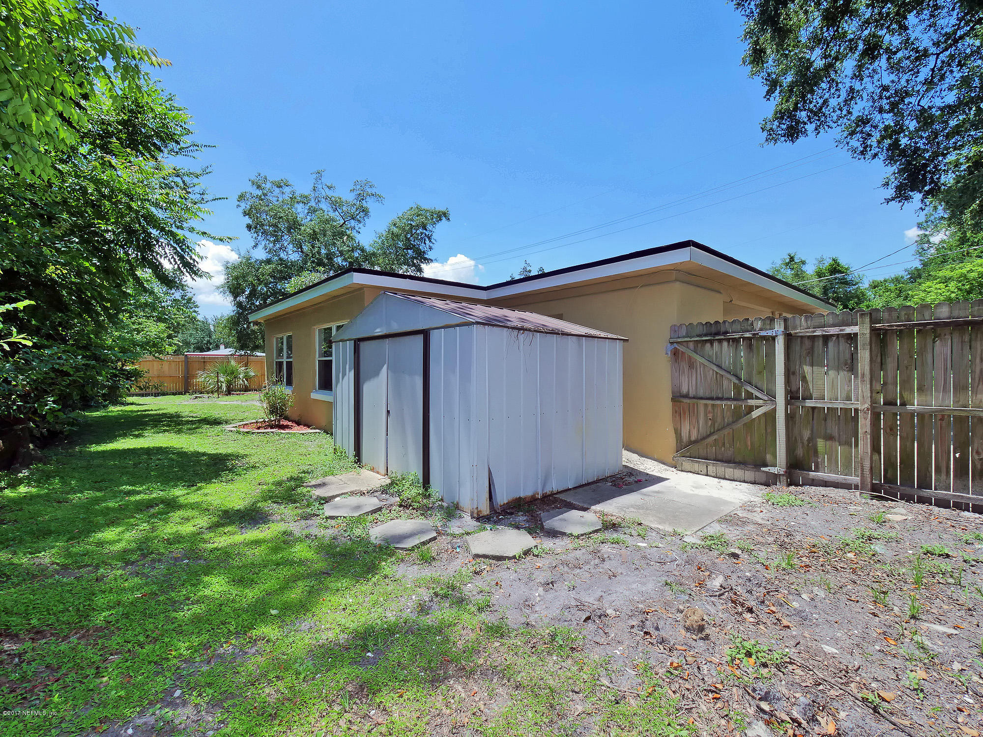 2448 Clemson Road Jacksonville, FL 32217 - Photo 20 of 21 a view of a small house with a yard