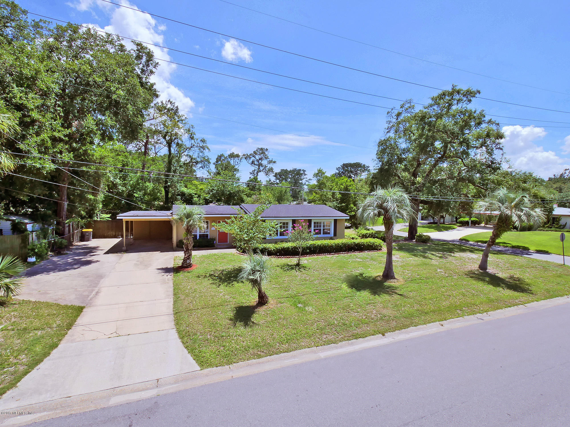 2448 Clemson Road Jacksonville, FL 32217 - Photo 2 of 21 a front view of a house with garden and trees