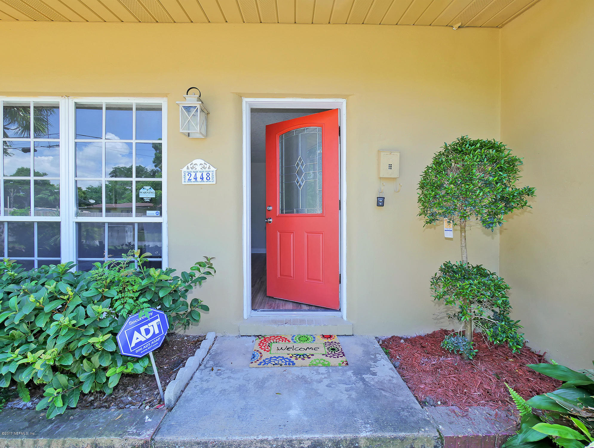 2448 Clemson Road Jacksonville, FL 32217 - Photo 4 of 21 a bunch of flowers in front of a door