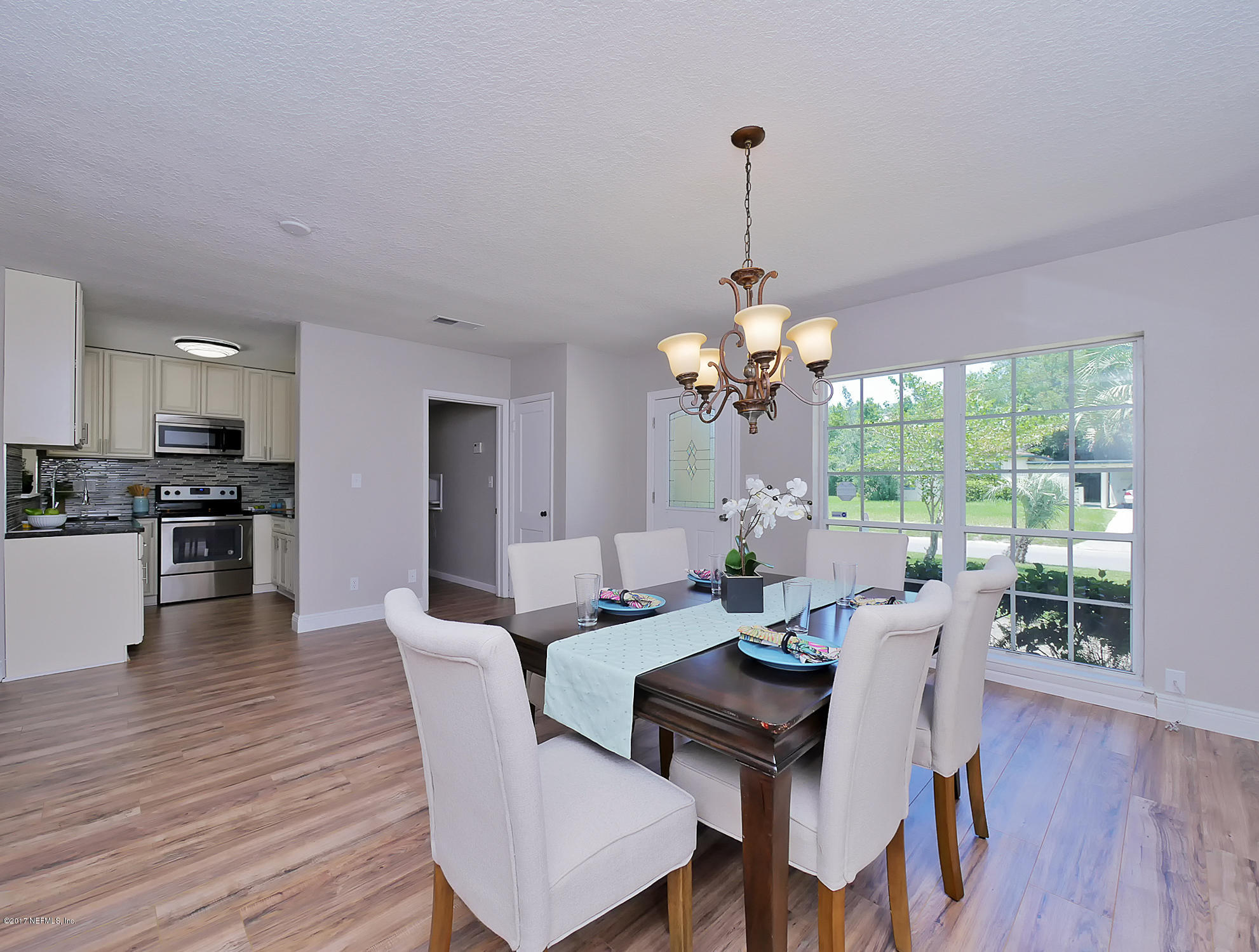 2448 Clemson Road Jacksonville, FL 32217 - Photo 6 of 21 a view of a dining room with furniture window and wooden floor