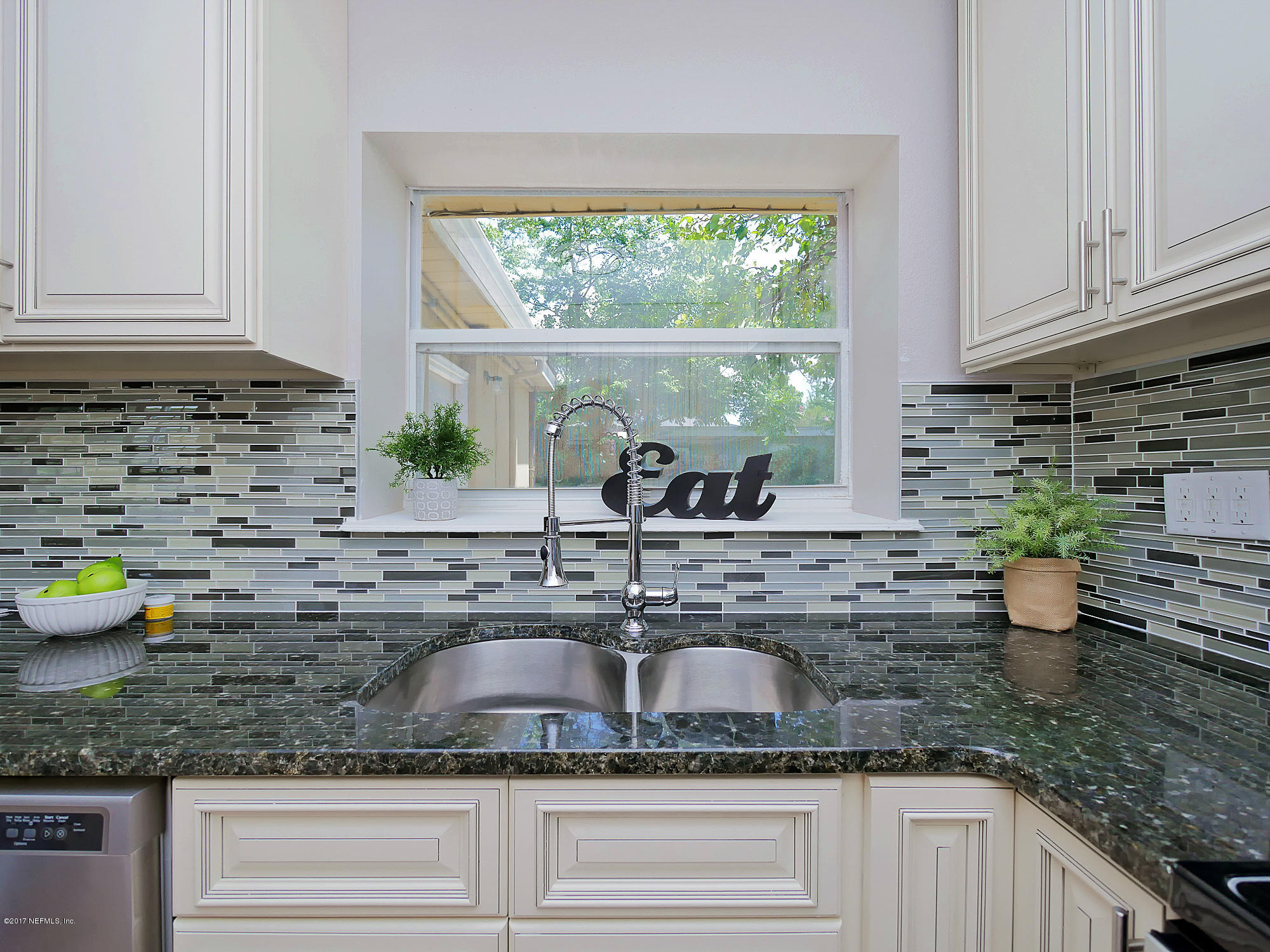 2448 Clemson Road Jacksonville, FL 32217 - Photo 9 of 21 a kitchen with granite countertop a sink a stove and cabinets