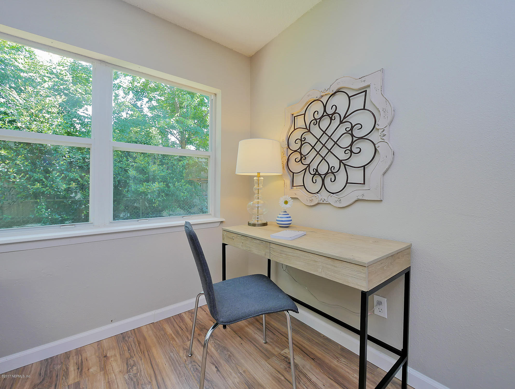 2448 Clemson Road Jacksonville, FL 32217 - Photo 10 of 21 a view of a workspace with furniture and a window