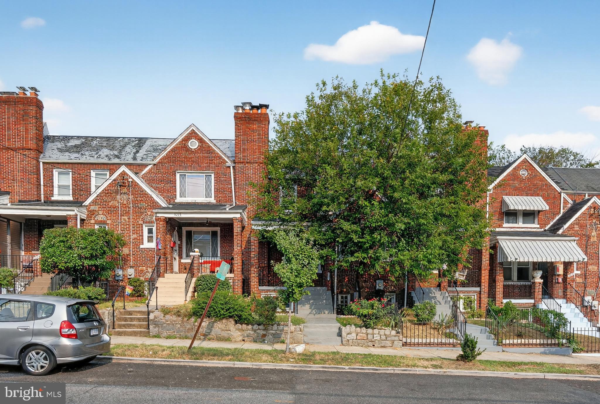 5221 2nd Street Northwest Washington, DC 20011 - Photo 1 of 39 a front view of a house with a yard and garage