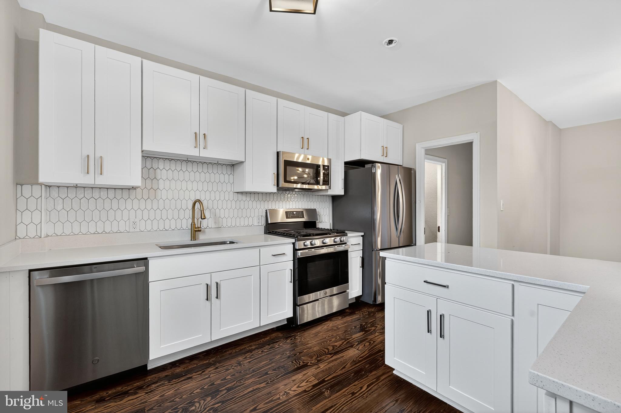 5221 2nd Street Northwest Washington, DC 20011 - Photo 11 of 39 a kitchen with cabinets stainless steel appliances a sink and wooden floor
