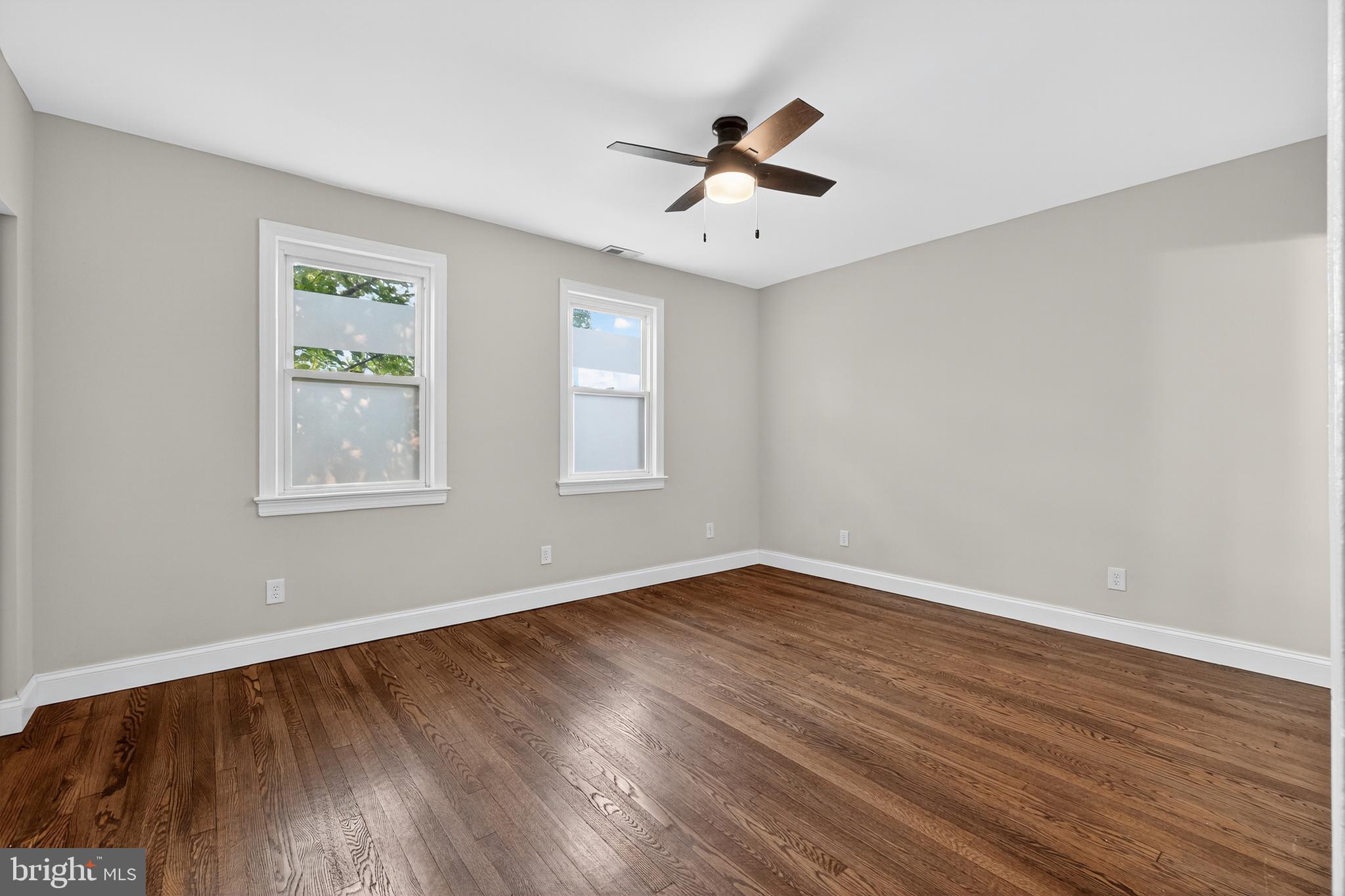 5221 2nd Street Northwest Washington, DC 20011 - Photo 18 of 39 a view of an empty room with wooden floor and a window