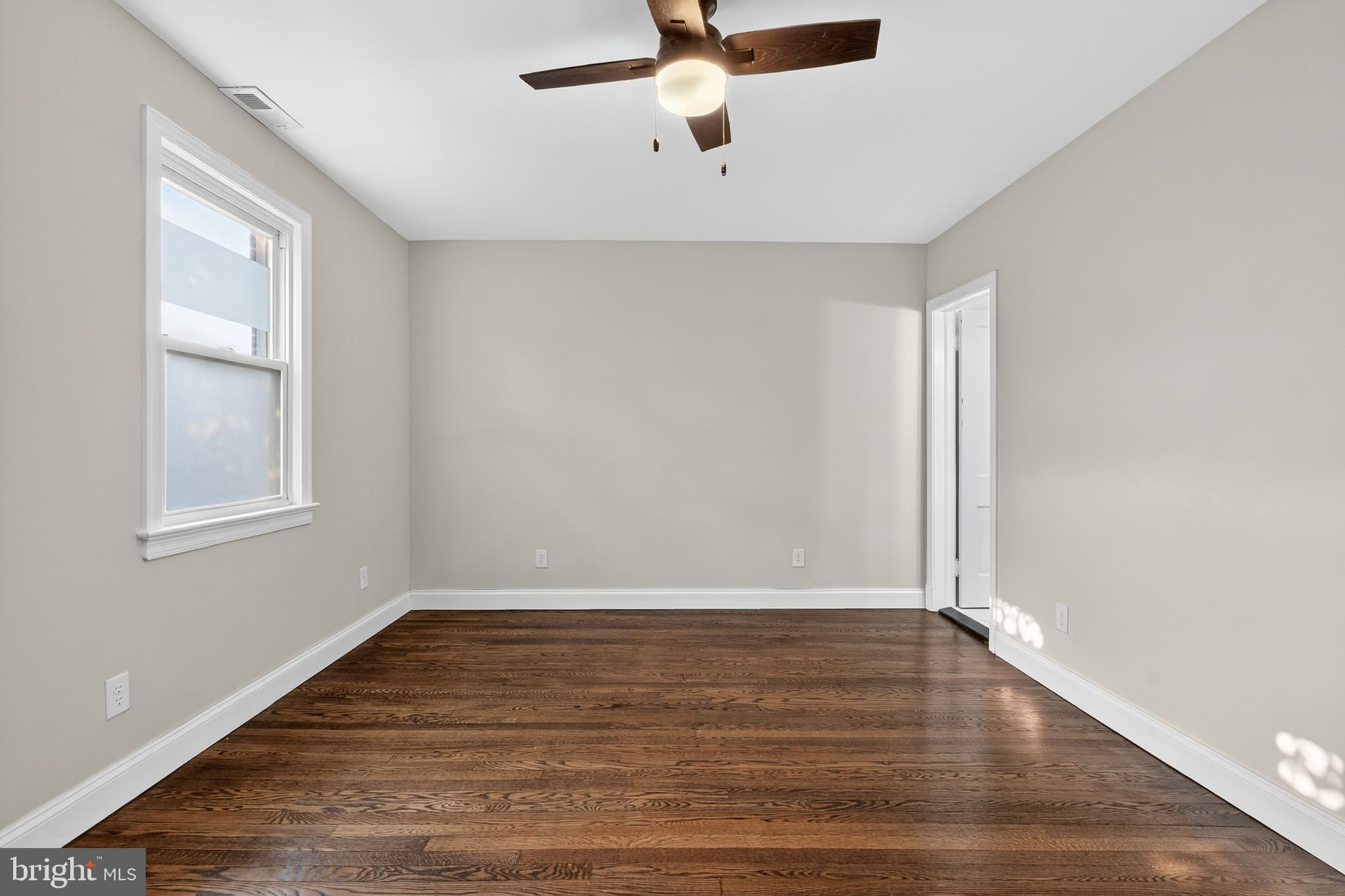 5221 2nd Street Northwest Washington, DC 20011 - Photo 20 of 39 wooden floor in an empty room with a window