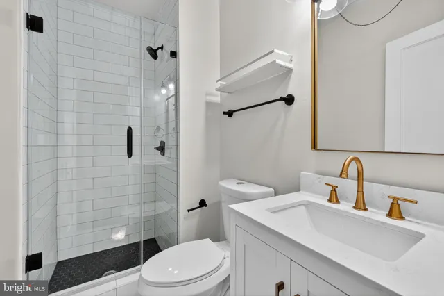 an empty room with wooden floor and a ceiling fan