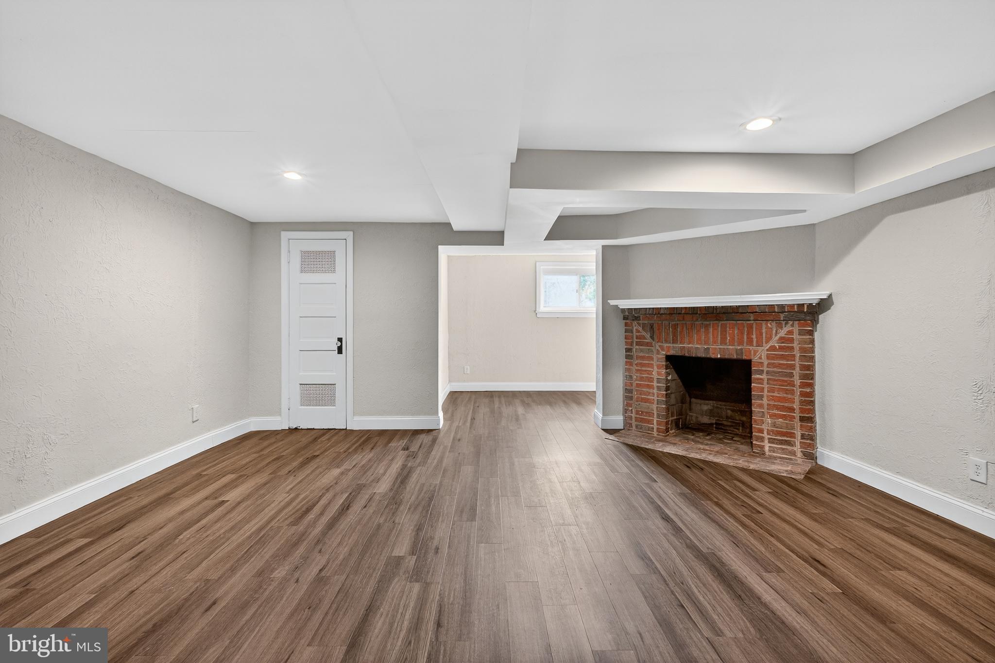 5221 2nd Street Northwest Washington, DC 20011 - Photo 28 of 39 an empty room with wooden floor and fireplace