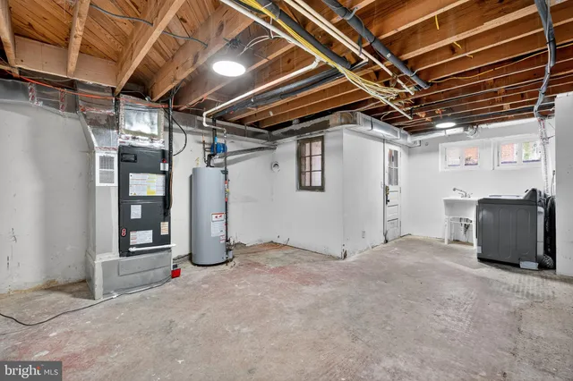 an empty room with wooden floor and fireplace