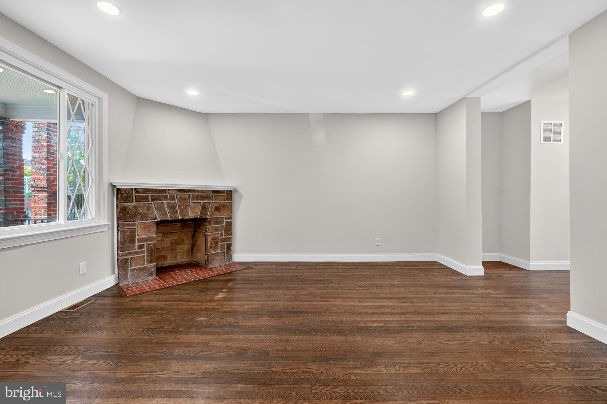 5221 2nd Street Northwest Washington, DC 20011 - Photo 5 of 39 a view of an empty room with wooden floor fireplace and a window