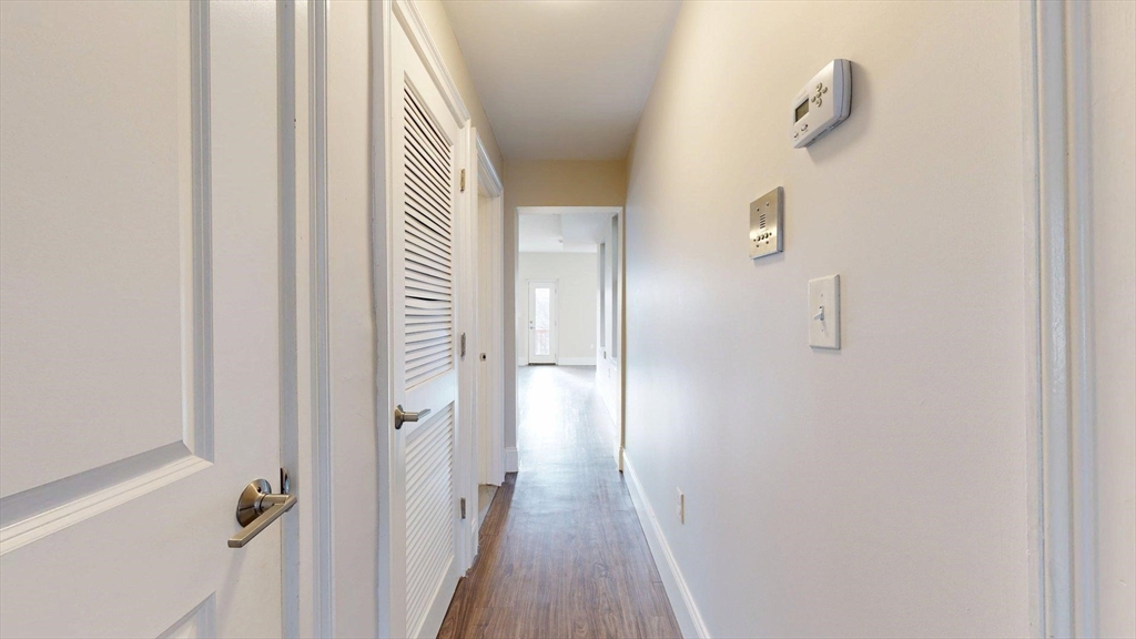 133 Paris Street, Unit 2 Boston, MA 02128 - Photo 13 of 26 a view of a hallway with wooden floor and closet