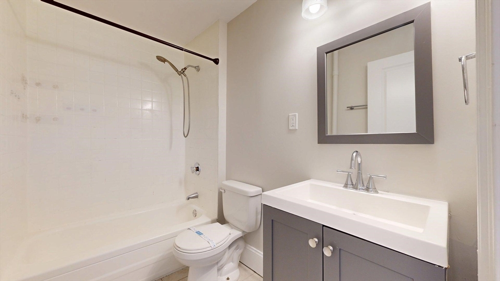 133 Paris Street, Unit 2 Boston, MA 02128 - Photo 14 of 26 a bathroom with a sink a toilet and a mirror