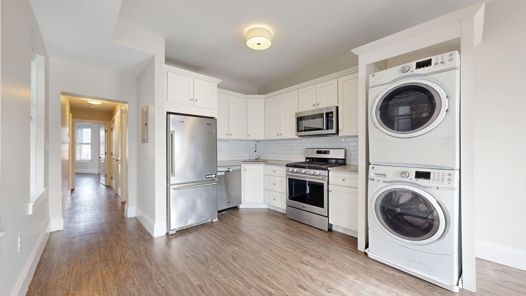 133 Paris Street, Unit 2 Boston, MA 02128 - Photo 2 of 26 a kitchen with a washer and dryer