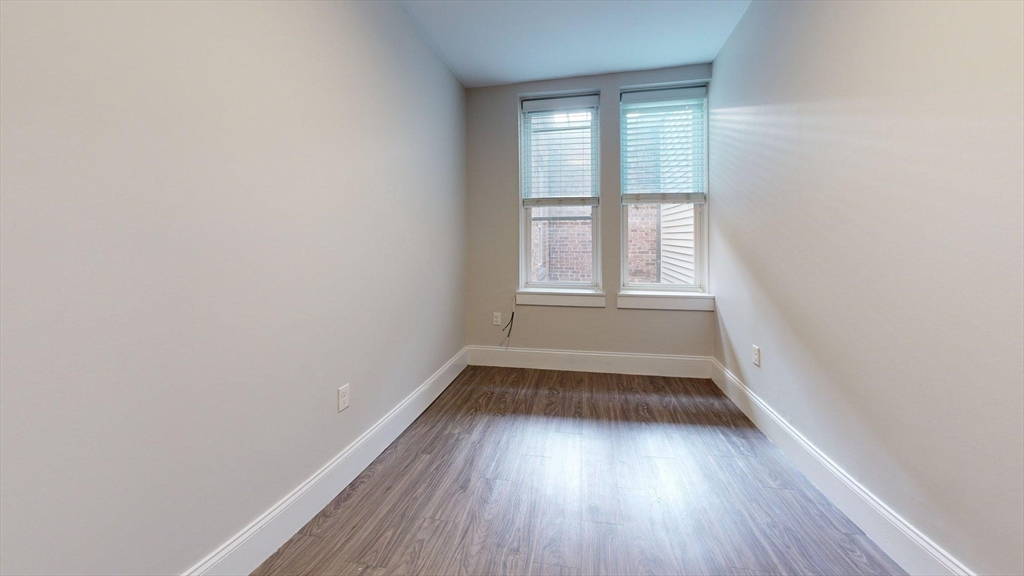 133 Paris Street, Unit 2 Boston, MA 02128 - Photo 22 of 26 a view of empty room with wooden floor and fan