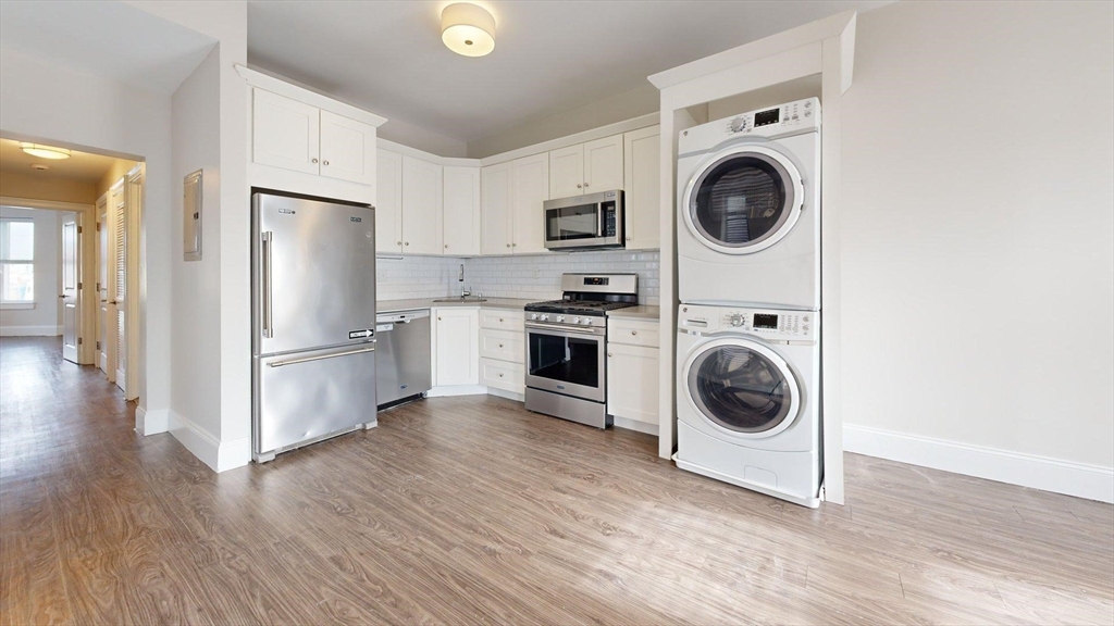 133 Paris Street, Unit 2 Boston, MA 02128 - Photo 24 of 26 a view of kitchen with washer and dryer