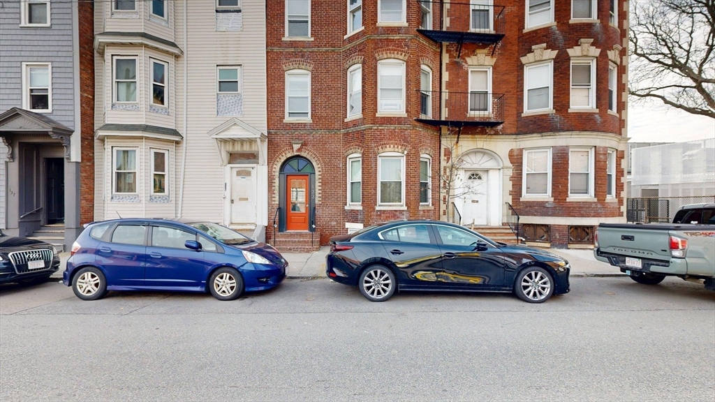 133 Paris Street, Unit 2 Boston, MA 02128 - Photo 26 of 26 a cars parked in front of a building