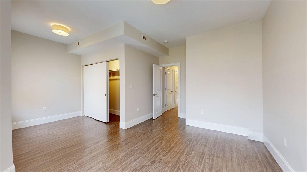 133 Paris Street, Unit 2 Boston, MA 02128 - Photo 6 of 26 a view of a room with wooden floor