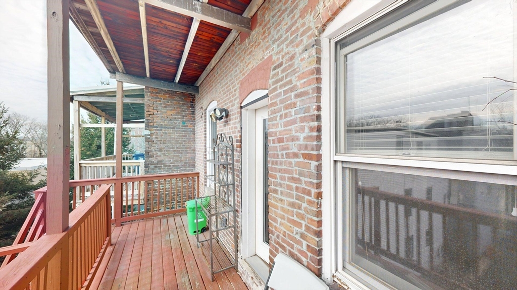 133 Paris Street, Unit 2 Boston, MA 02128 - Photo 9 of 26 a view of a balcony with wooden floor