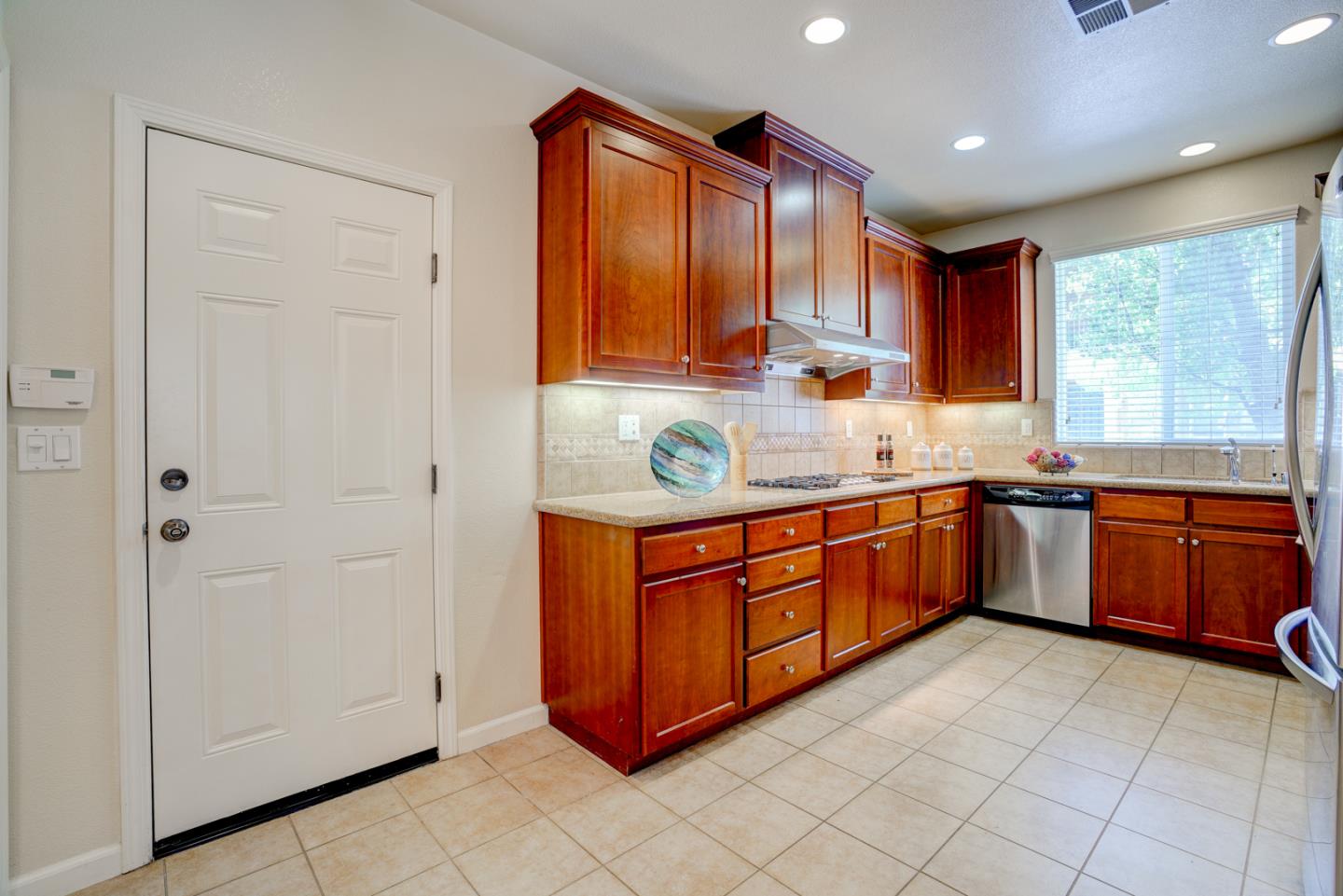 5300 Fioli Loop San Ramon, CA 94582 - Photo 11 of 38 a kitchen with stainless steel appliances granite countertop a stove a sink and a refrigerator