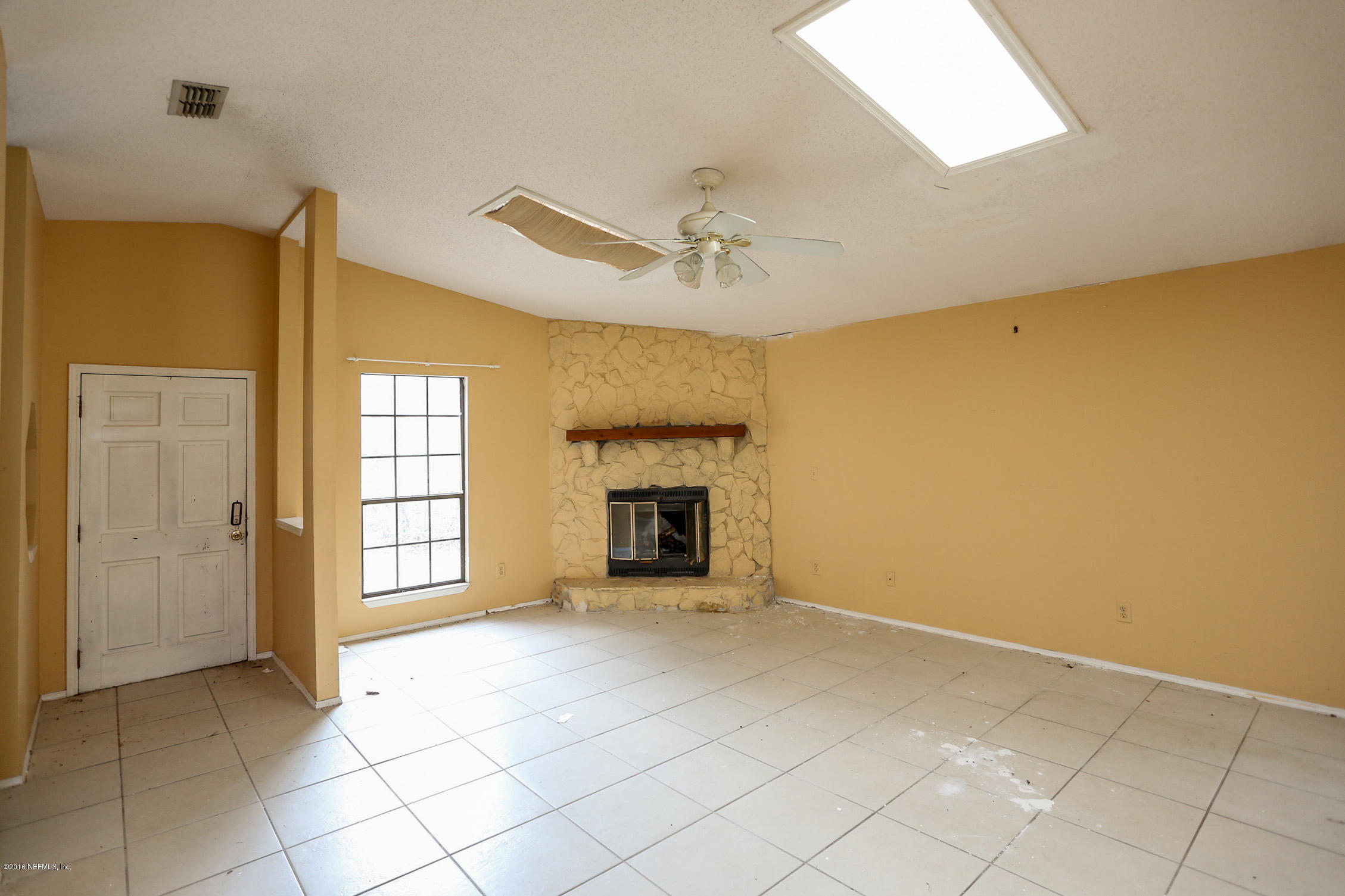 3165 Kings Road St. Augustine, FL 32086 - Photo 6 of 15 a view of an empty room with a fireplace and a window