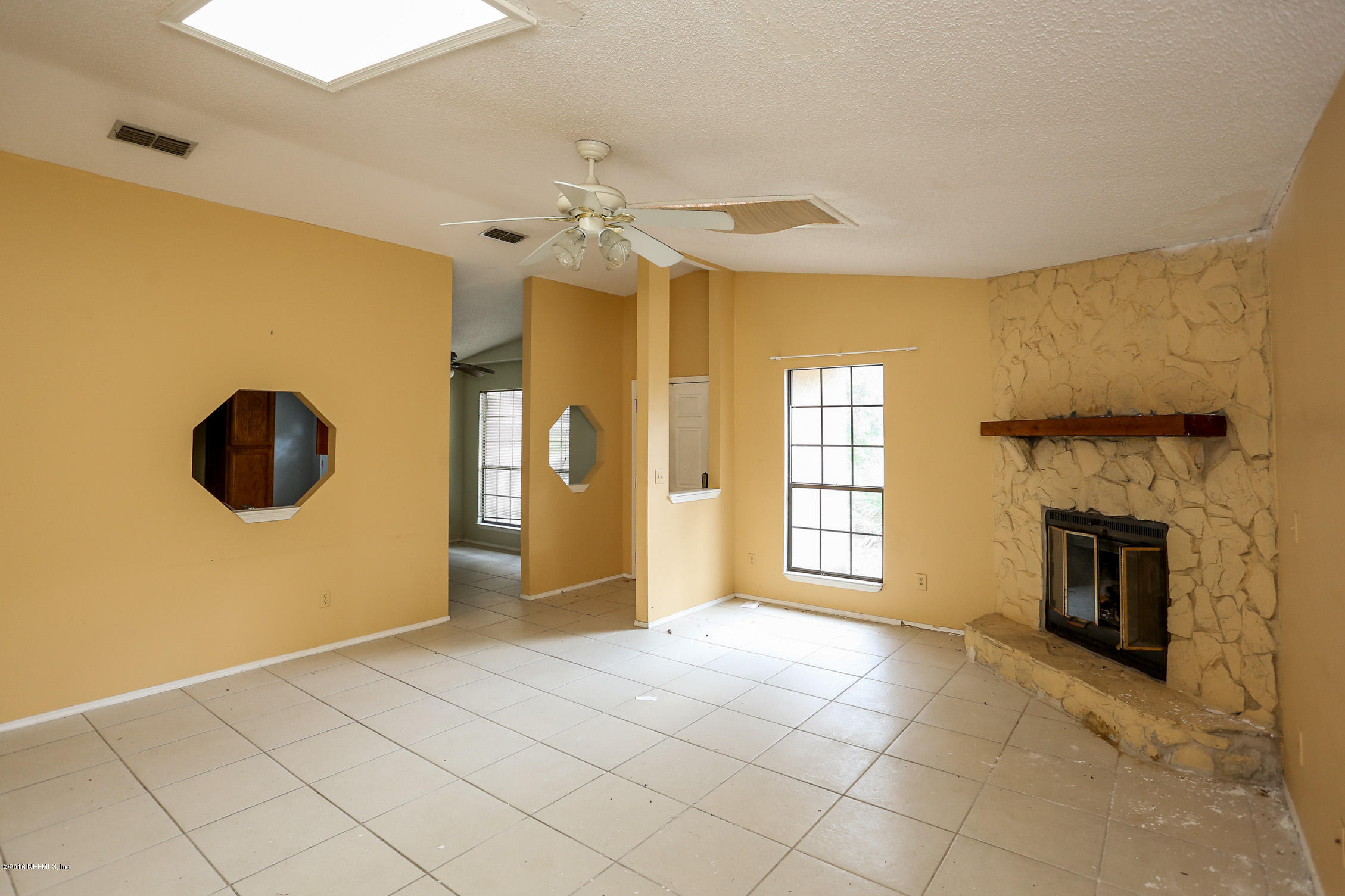 3165 Kings Road St. Augustine, FL 32086 - Photo 7 of 15 a view of an empty room with a fireplace and a window