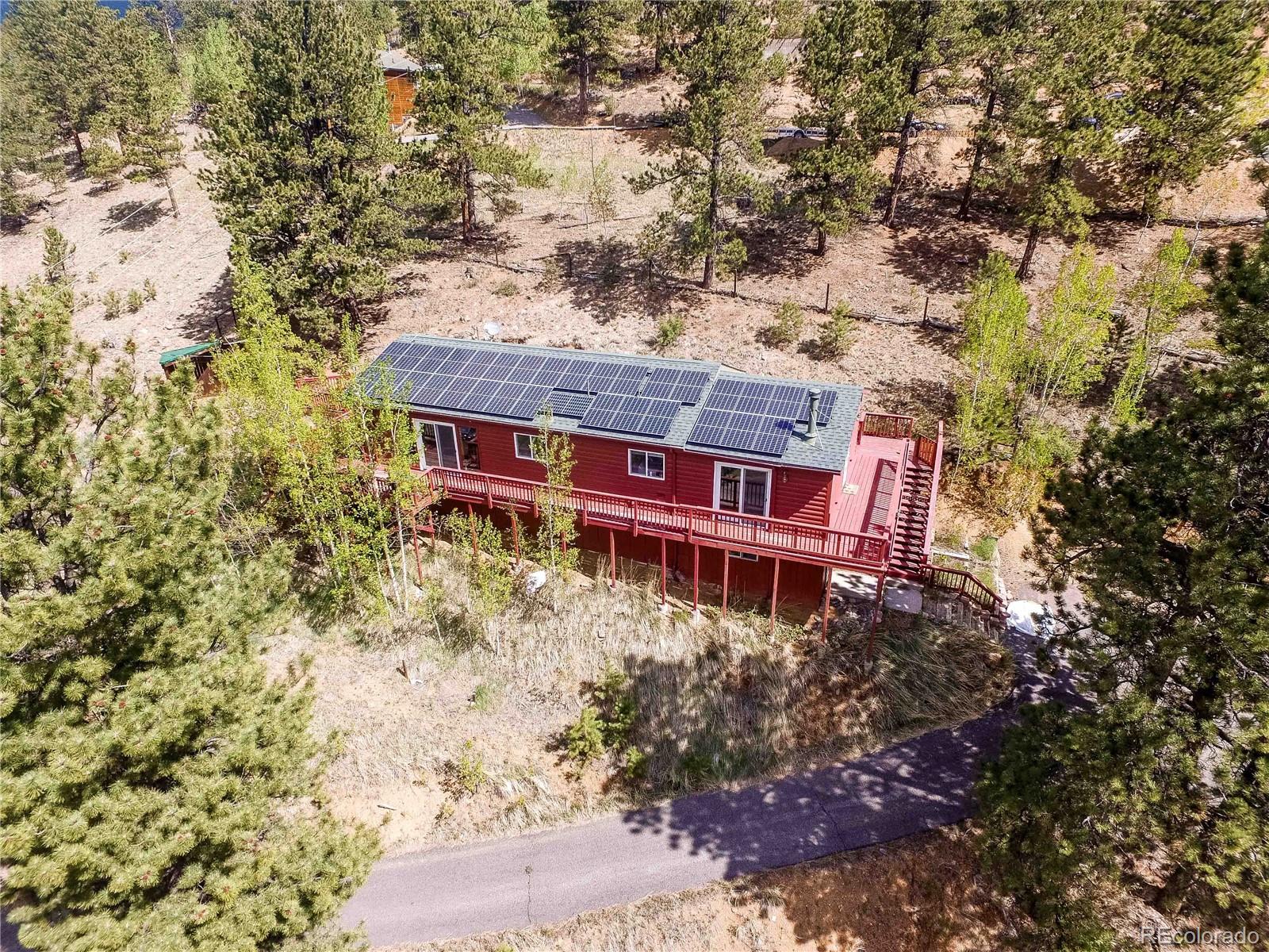 229 Wilkins Road Bailey, CO 80421 - Photo 4 of 28 a view of a house with a yard