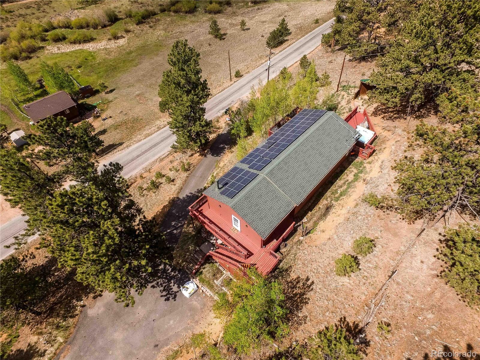 229 Wilkins Road Bailey, CO 80421 - Photo 7 of 28 an aerial view of a house with a yard and mountain view in back