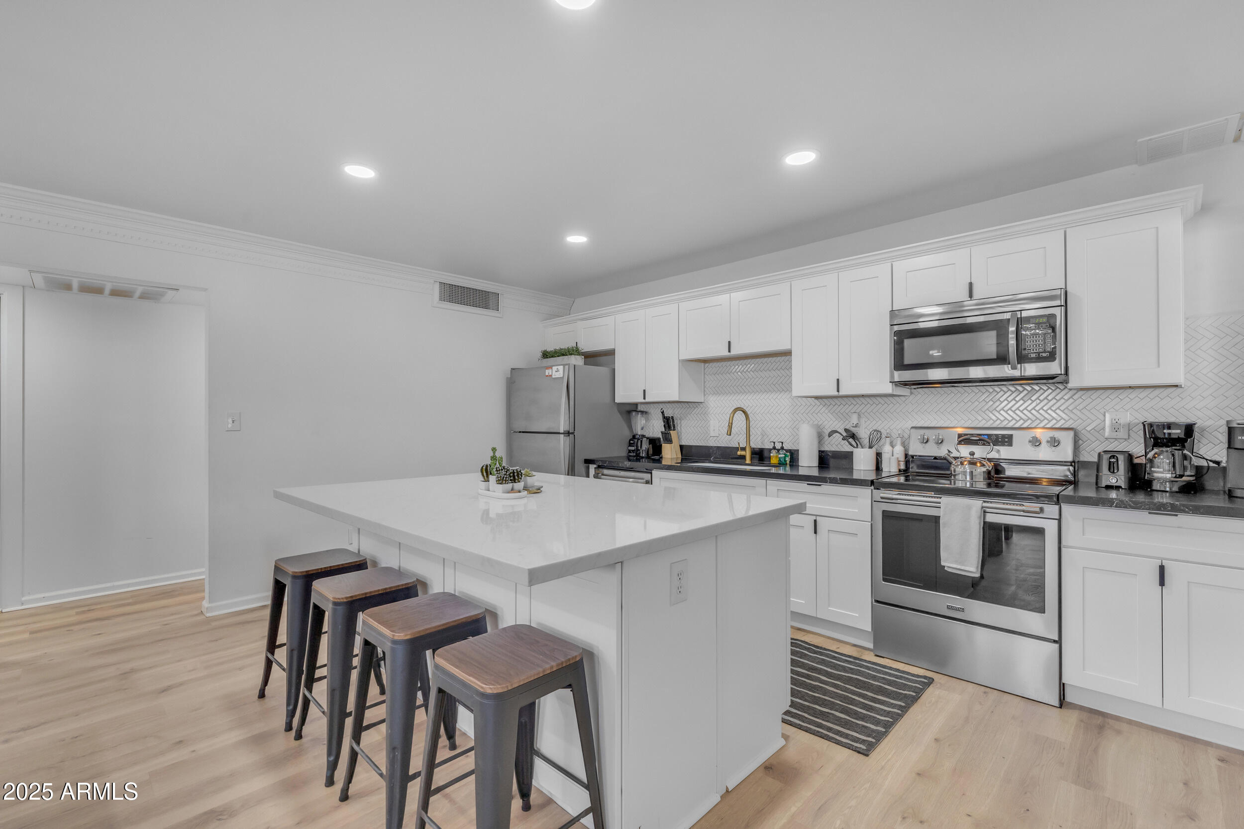 6943 East Granada Road Scottsdale, AZ 85257 - Photo 5 of 19 a kitchen with appliances cabinets and a sink