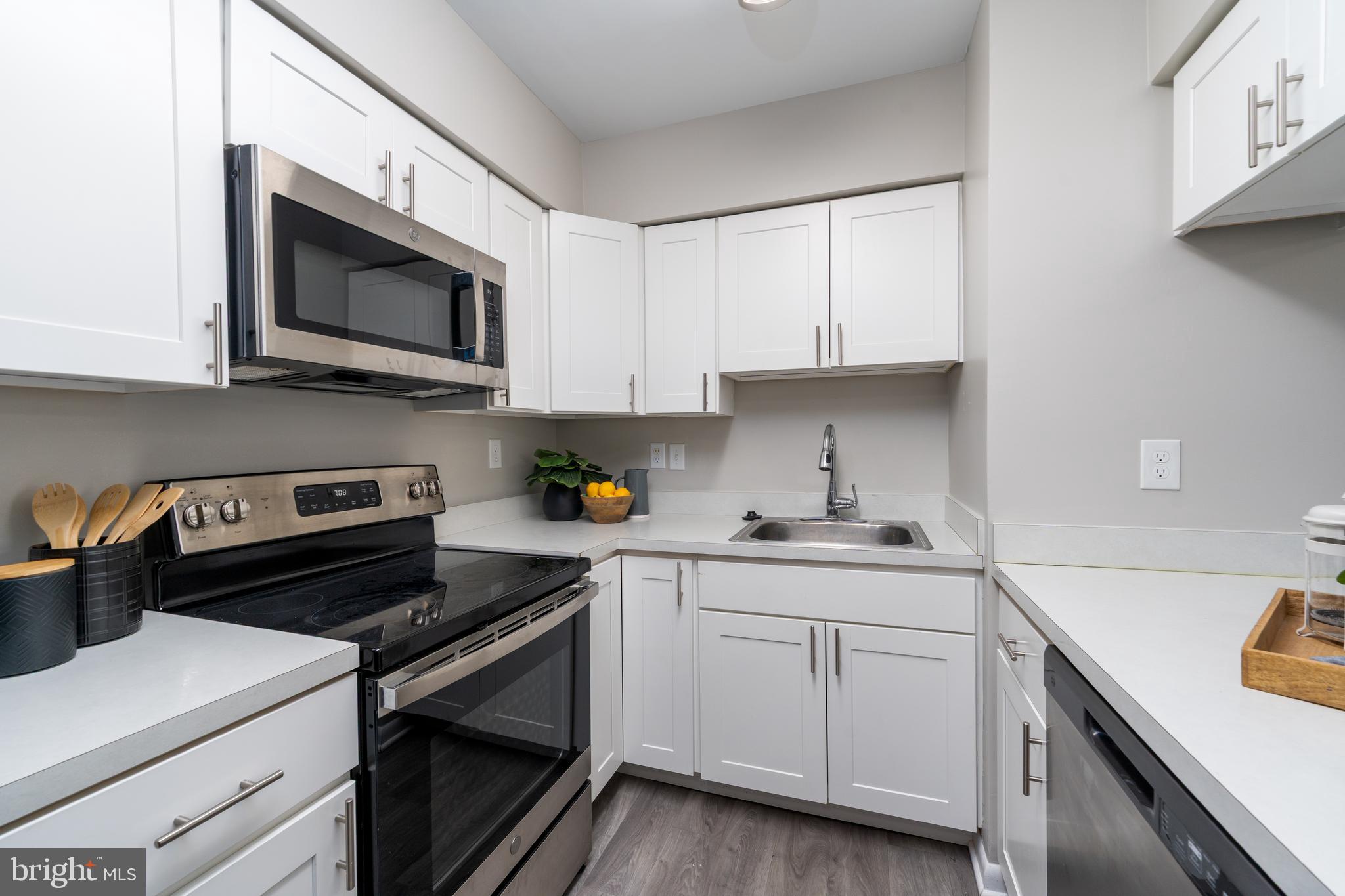 2213 Lowells Glen Road, Unit L Baltimore, MD 21234 - Photo 11 of 26 a kitchen with cabinets stainless steel appliances and a sink